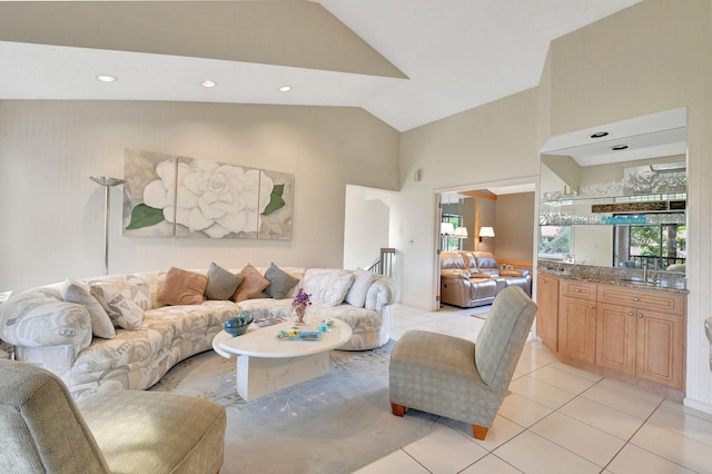 living room with high vaulted ceiling and light tile patterned floors