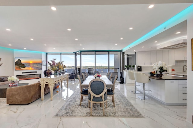 dining room featuring recessed lighting and marble finish floor