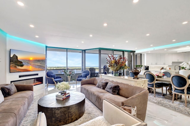 living room featuring expansive windows and sink