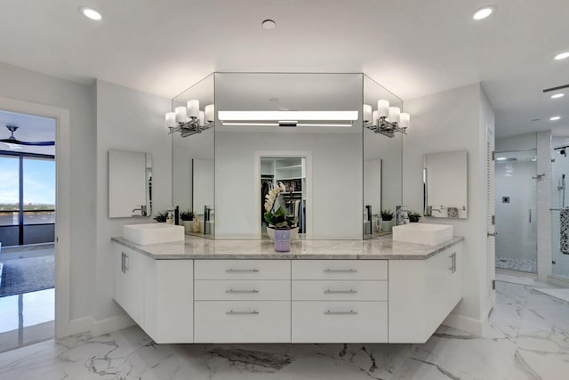 bathroom with walk in shower, vanity, and ceiling fan with notable chandelier