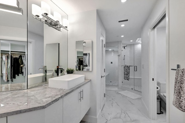 bathroom with toilet, vanity, and walk in shower