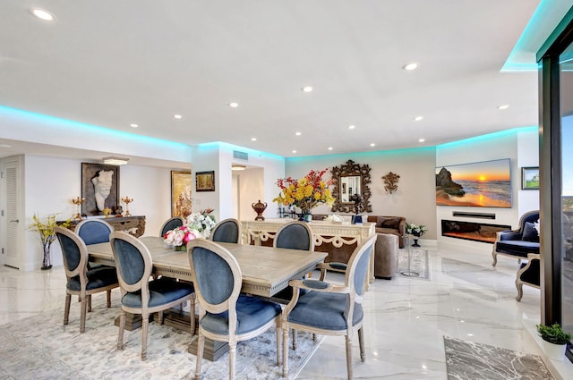 dining space with recessed lighting and marble finish floor