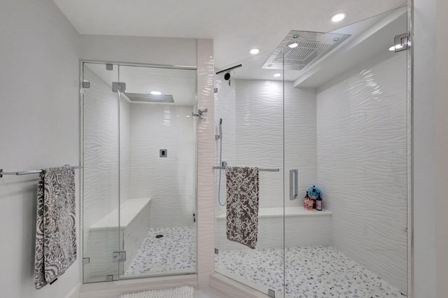 bathroom featuring a shower with door