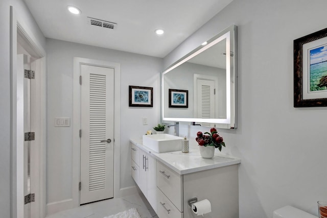 bathroom featuring vanity and toilet