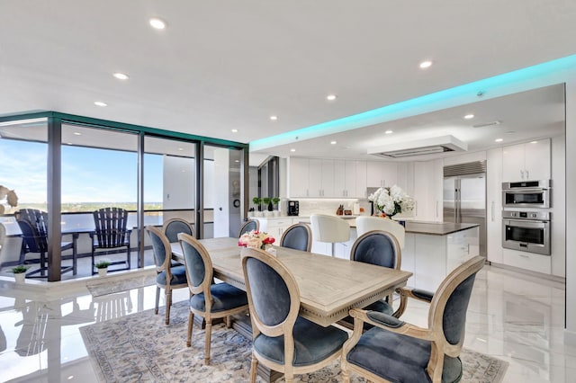 dining area featuring recessed lighting, marble finish floor, and floor to ceiling windows