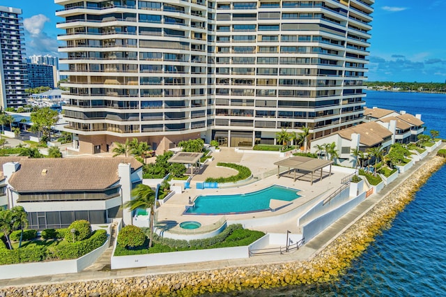 exterior space with a community pool and a water view