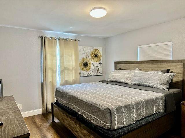 bedroom featuring dark hardwood / wood-style flooring