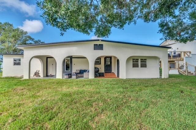 back of house with a patio area and a lawn