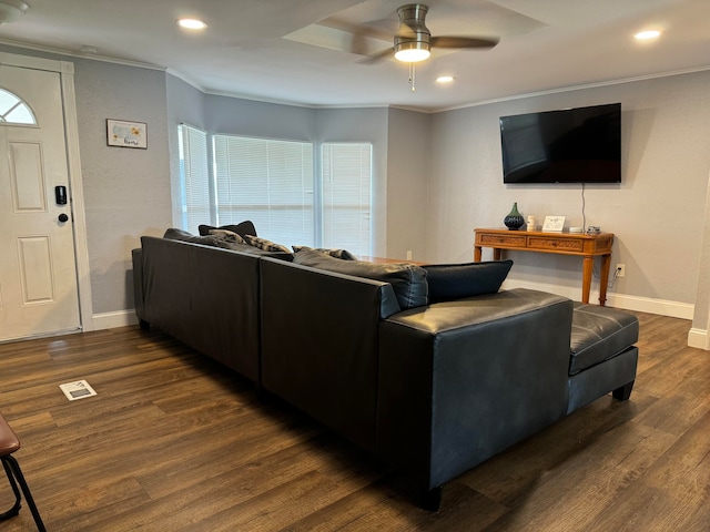 living room with ornamental molding, dark hardwood / wood-style flooring, and ceiling fan