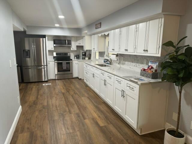 kitchen featuring white cabinets, sink, dark wood-type flooring, and appliances with stainless steel finishes