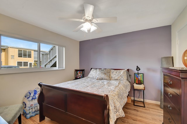 bedroom featuring light wood-type flooring and ceiling fan