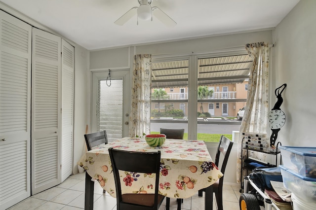 tiled dining room featuring ceiling fan