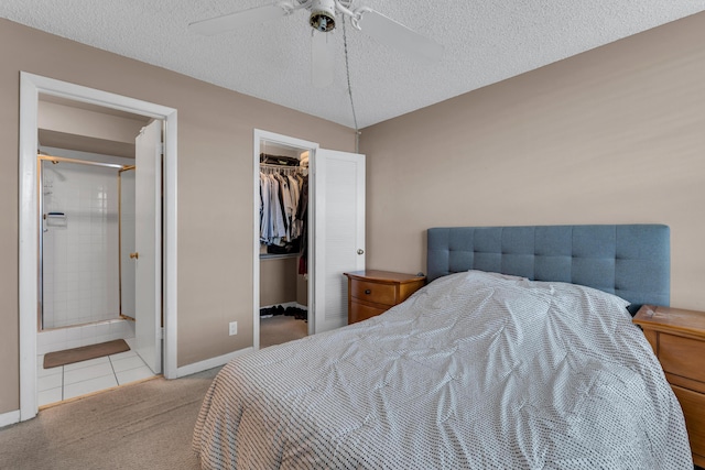 9 Royal Palm Way Unit 4020, Boca Raton, FL 33432 - carpeted bedroom featuring a textured ceiling, a spacious closet, a closet, baseboards, and ceiling fan
