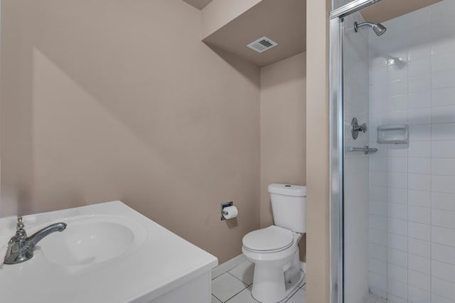 bathroom featuring toilet, an enclosed shower, sink, and tile patterned flooring