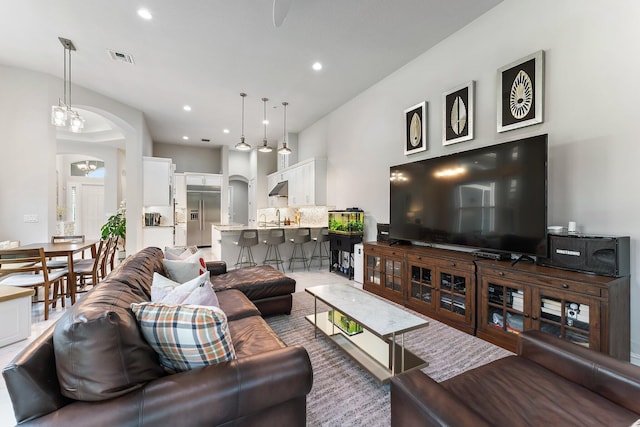 living room featuring a chandelier and sink