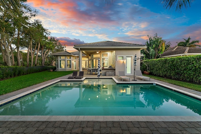 pool at dusk with ceiling fan