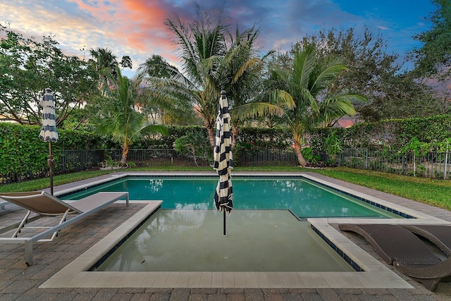 view of pool at dusk