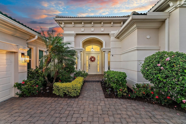 view of exterior entry at dusk