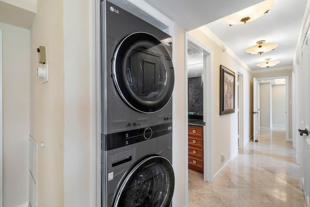 washroom featuring light tile patterned floors and stacked washer and clothes dryer