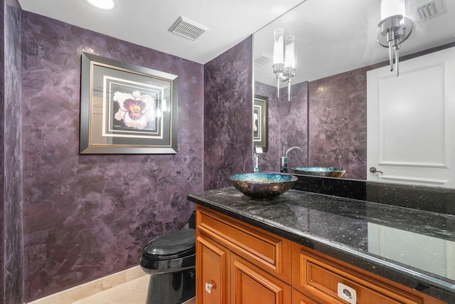 bathroom with toilet and vanity