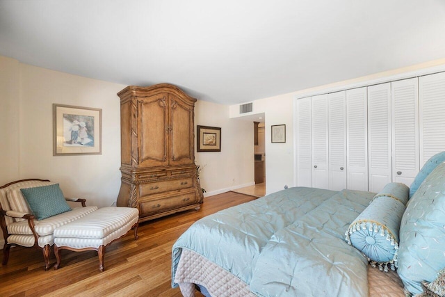 bedroom with a closet and light hardwood / wood-style flooring