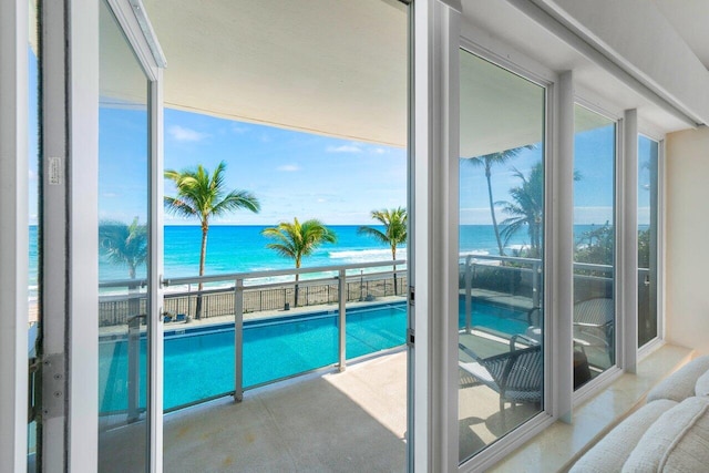 view of swimming pool with a patio and a water view