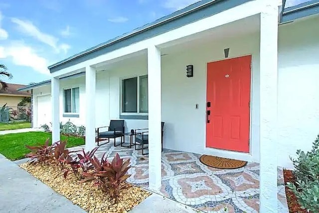 view of exterior entry with covered porch