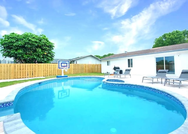 view of pool with a patio area and grilling area