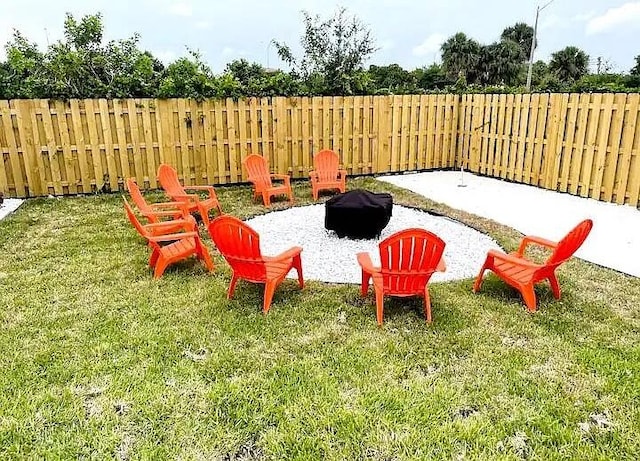 view of yard with an outdoor fire pit and a patio