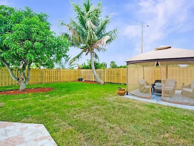 view of yard featuring a gazebo and a patio area