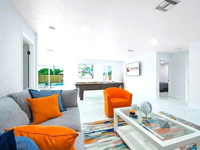 living room featuring a textured ceiling and billiards