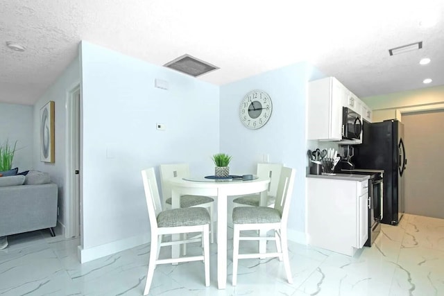 dining room featuring a textured ceiling