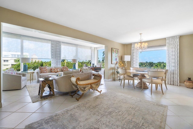 living room featuring tile patterned floors, baseboards, a wealth of natural light, and a chandelier