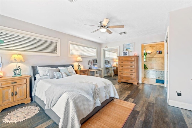 bedroom featuring ceiling fan, dark wood-type flooring, and a textured ceiling