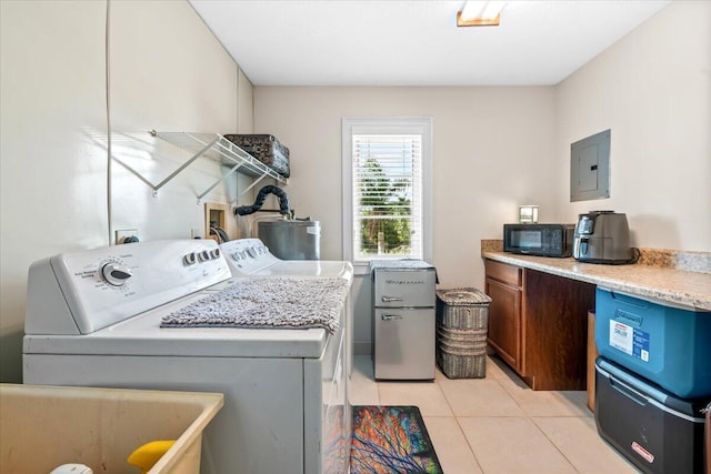 laundry room featuring sink, washer and dryer, light tile patterned floors, water heater, and electric panel