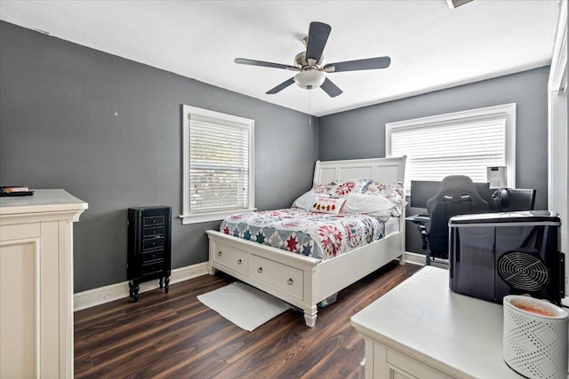 bedroom with multiple windows, dark wood-type flooring, and ceiling fan