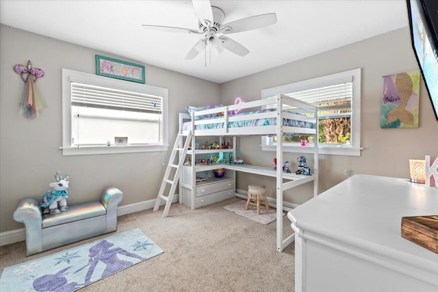 bedroom featuring ceiling fan, light colored carpet, and multiple windows