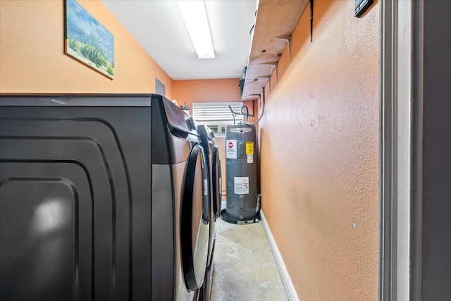 laundry area with washer and clothes dryer and water heater