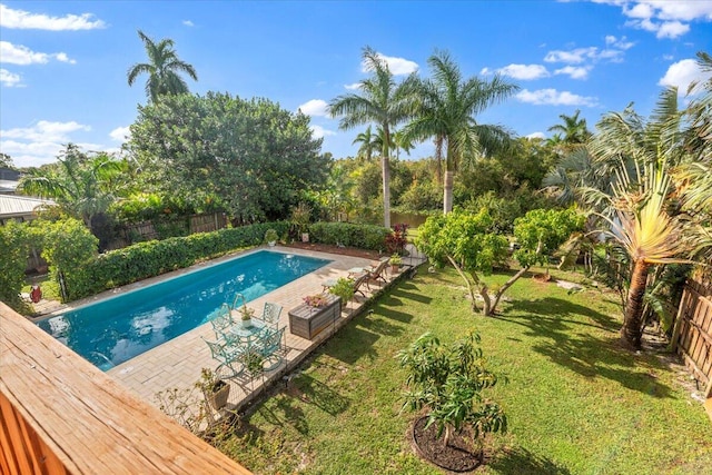 view of pool with a lawn and a patio area