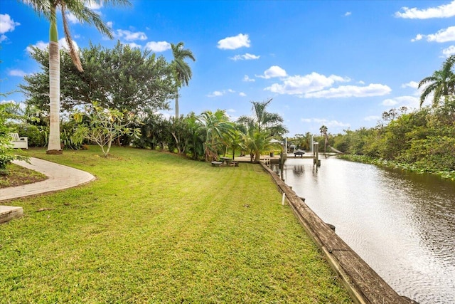 view of property's community with a water view and a yard