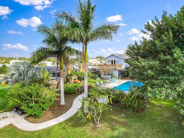 view of pool with a lawn and a patio