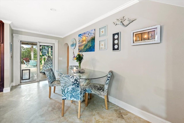 dining space featuring crown molding