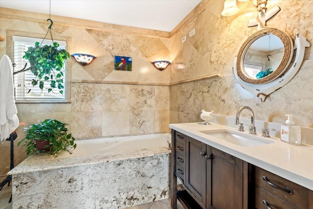 bathroom featuring vanity, tile walls, and tiled tub