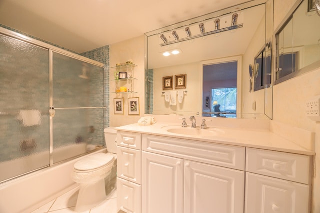 full bathroom with tile patterned flooring, vanity, toilet, and shower / bath combination with glass door