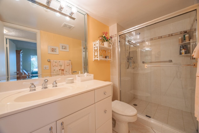 bathroom with tile patterned floors, vanity, toilet, and an enclosed shower