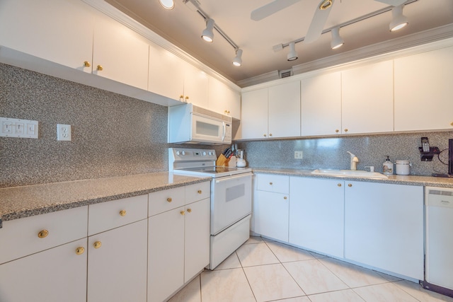 kitchen featuring backsplash, track lighting, white appliances, sink, and white cabinets