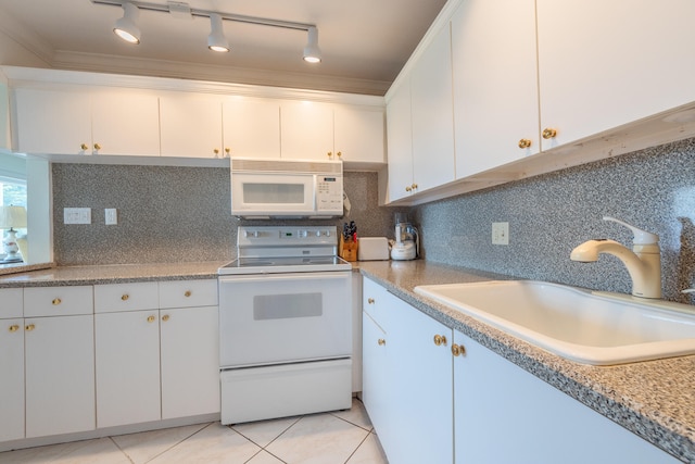 kitchen with white cabinetry, sink, light tile patterned floors, and white appliances