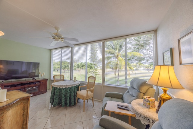 tiled living room with ceiling fan and a healthy amount of sunlight