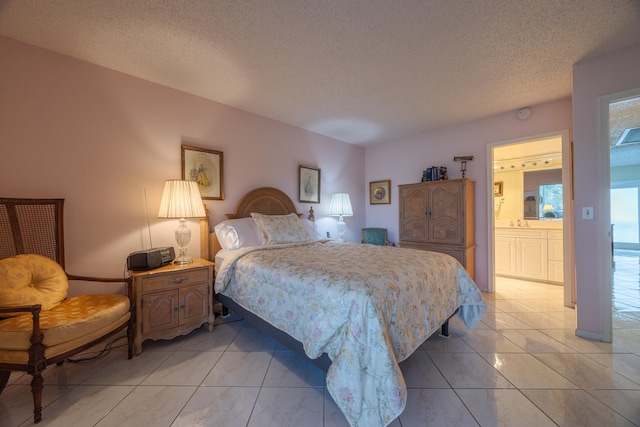 tiled bedroom featuring a textured ceiling and connected bathroom