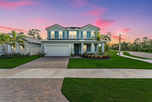 view of front of house featuring a yard and a garage